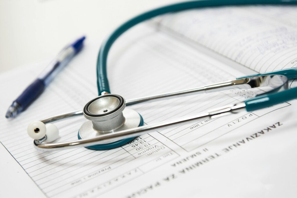 medical-appointment-doctor-healthcare-40568-40568 A stethoscope and pen resting on a medical report in a healthcare setting.